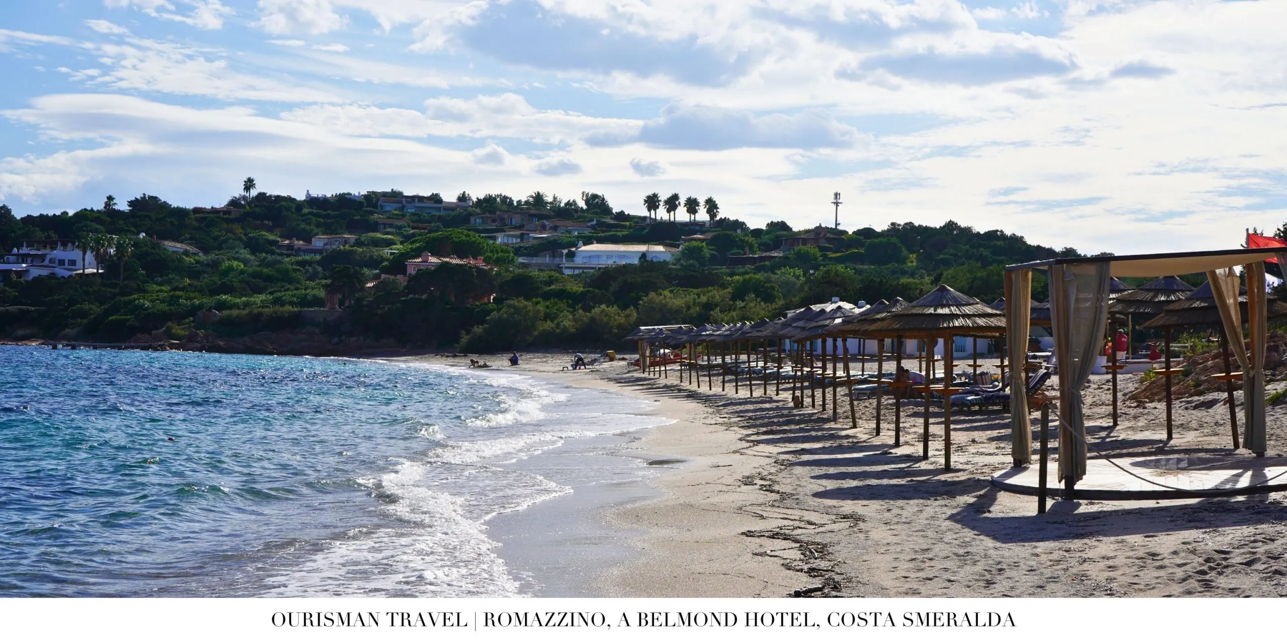 Soft white sand beach at Romazzino Belmond with clear turquoise water