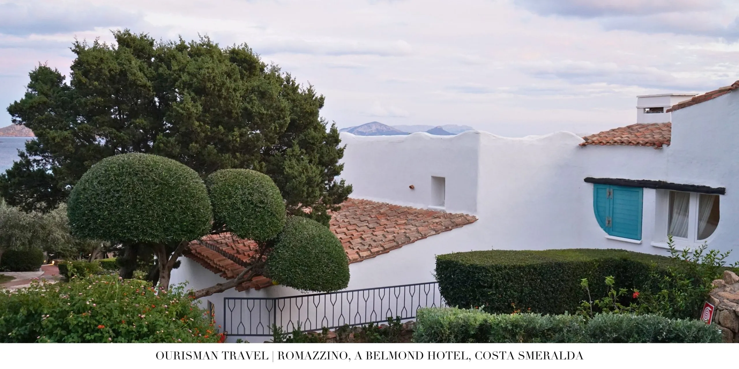 Exterior of Romazzino, A Belmond Hotel featuring iconic whitewashed Mediterranean architecture