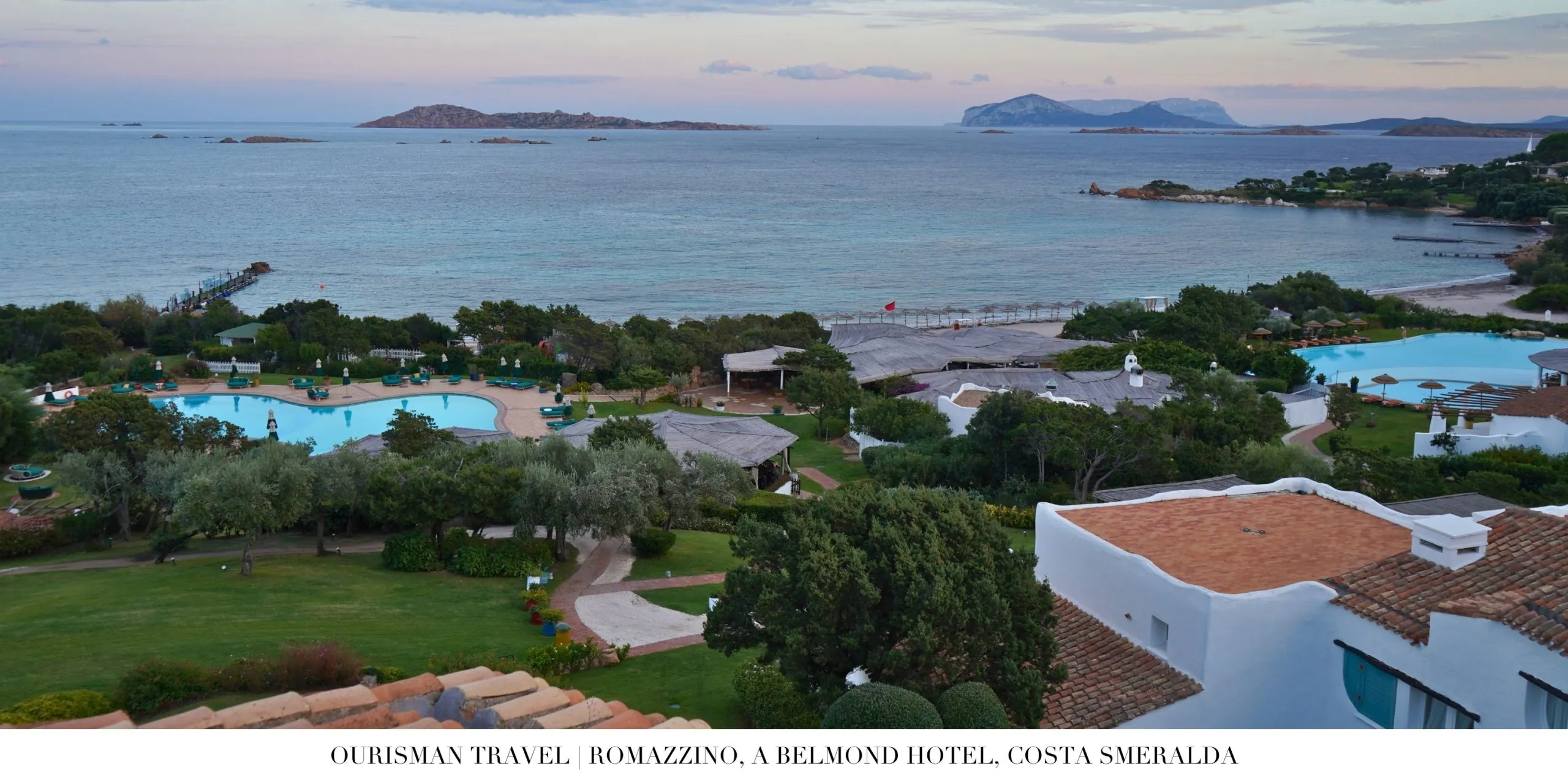 Aerial view of Romazzino Belmond pools set within lush coastal landscaping