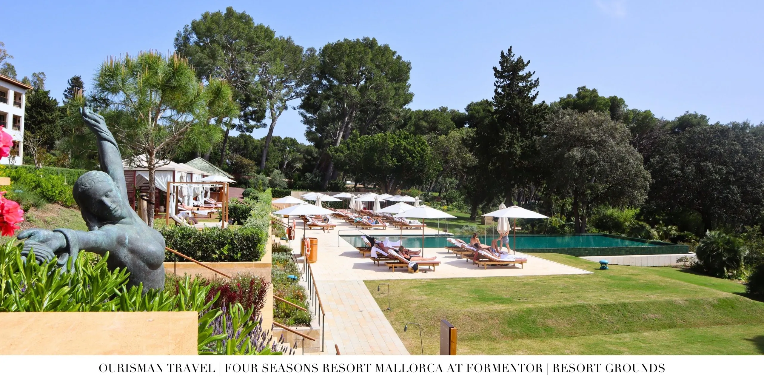 Pool and lounge area at Four Seasons Resort Mallorca at Formentor surrounded by pine trees