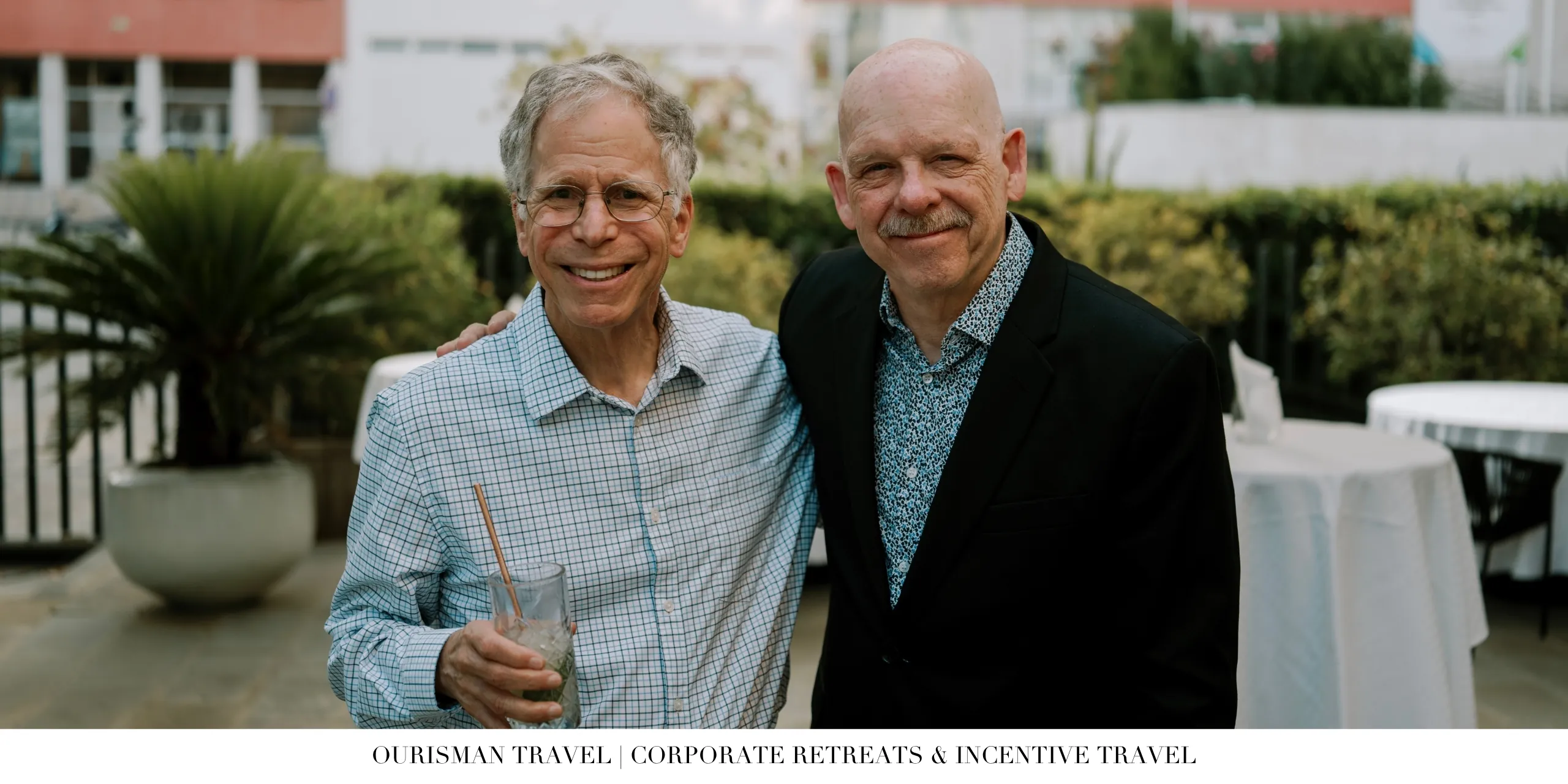 Two attendees posing together during a corporate retreat networking event