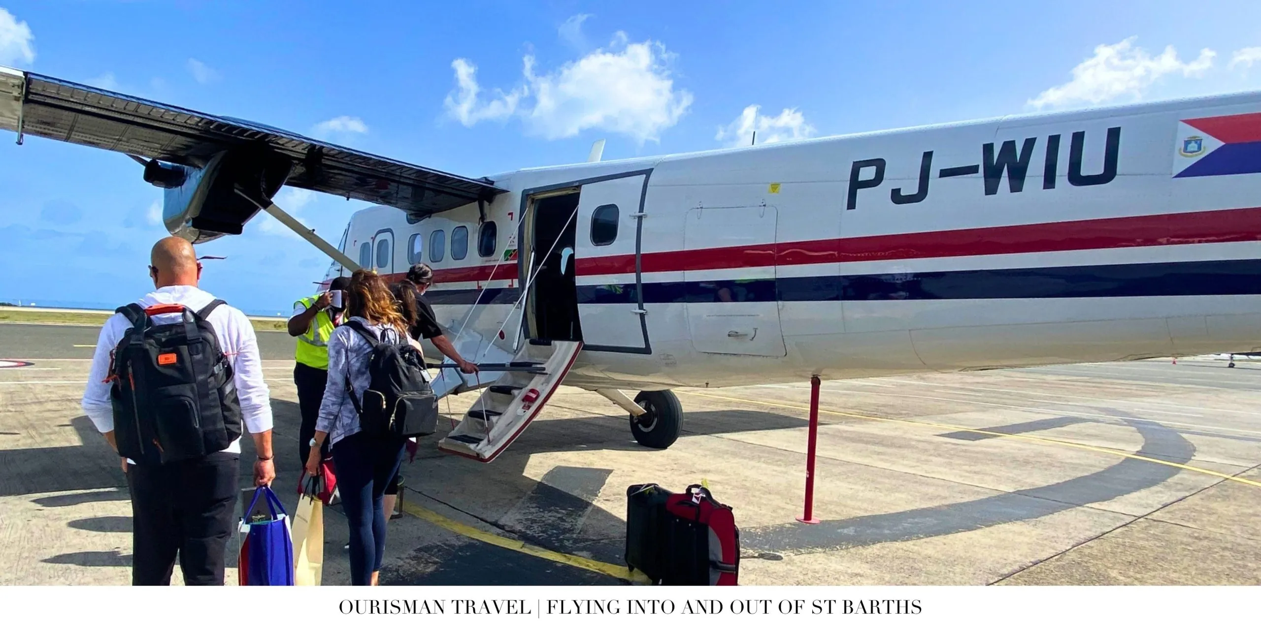Private jet arriving in St. Barth above the turquoise Caribbean Sea
