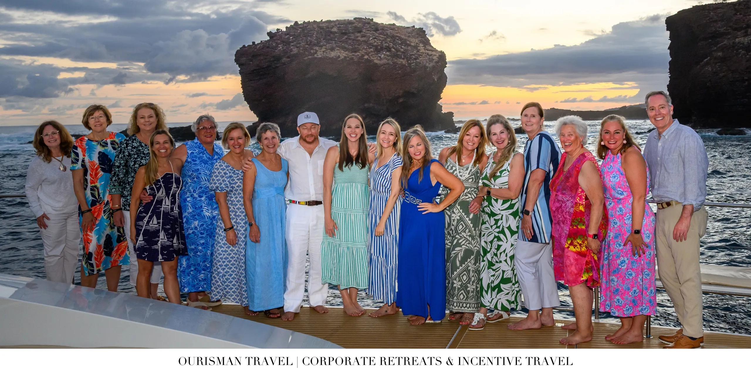 Corporate incentive travel group photo aboard a luxury catamaran at sunset