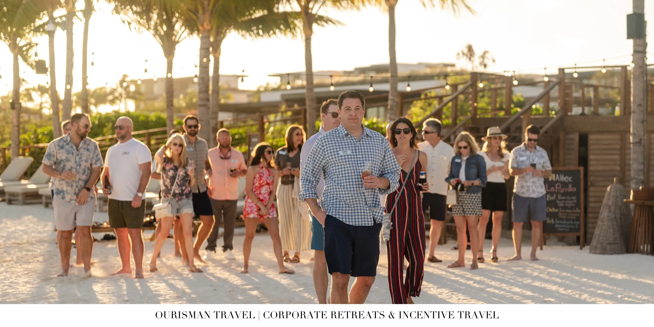 Corporate retreat attendees gathering for a beachfront welcome reception at a luxury resort