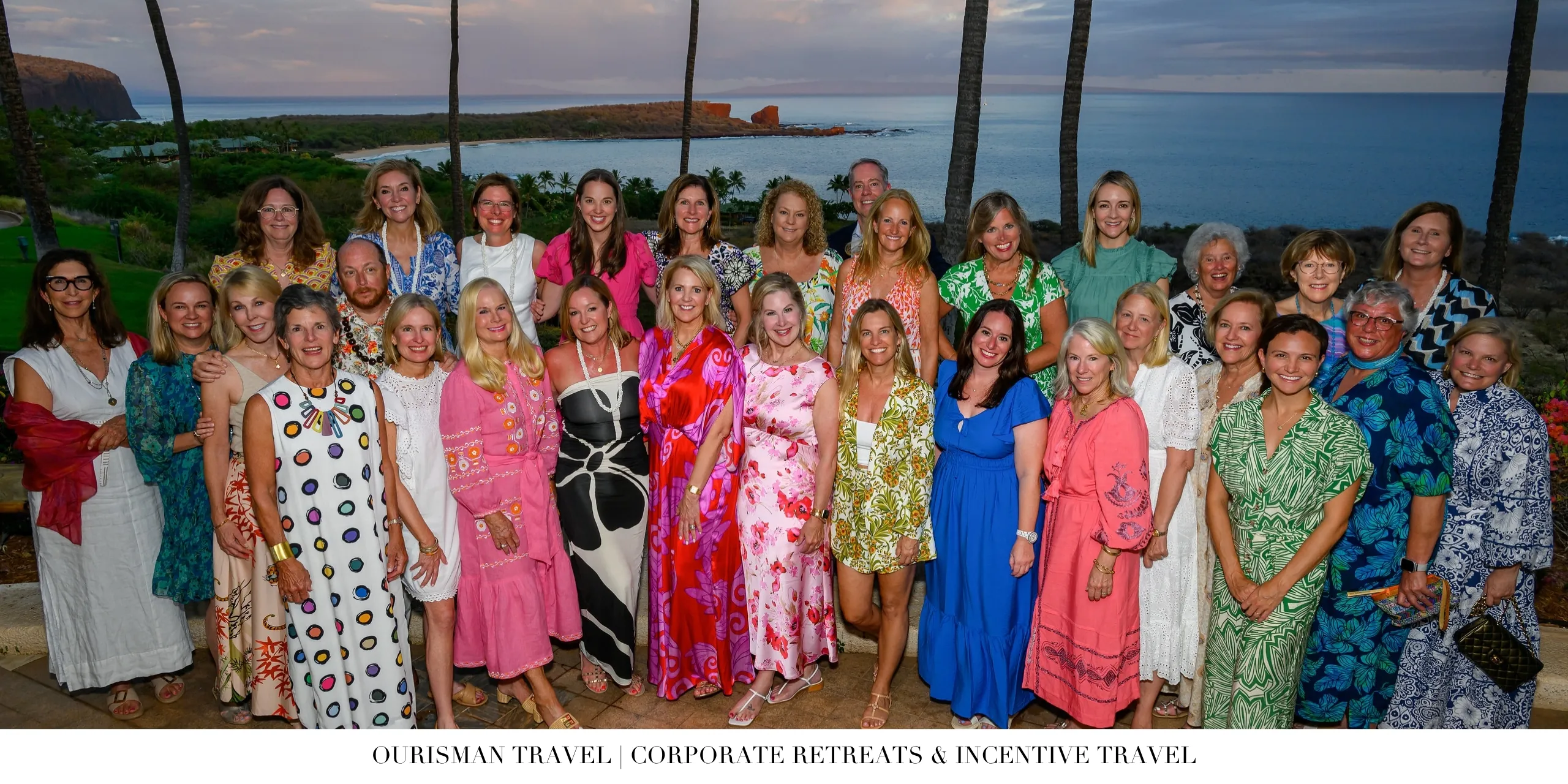 Corporate incentive travel group photo overlooking the ocean at sunset