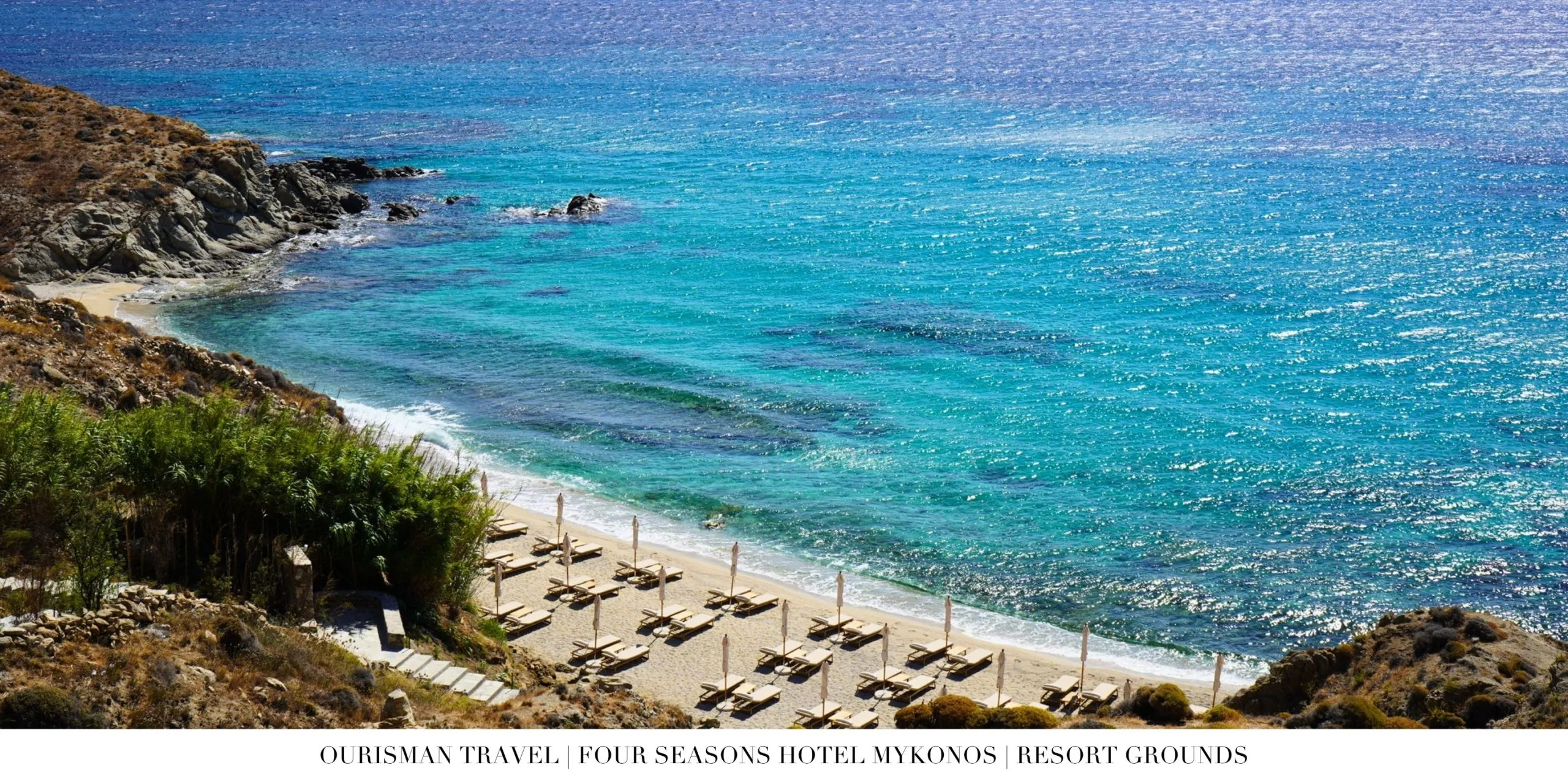 Private beach at Four Seasons Mykonos with clear Aegean Sea water