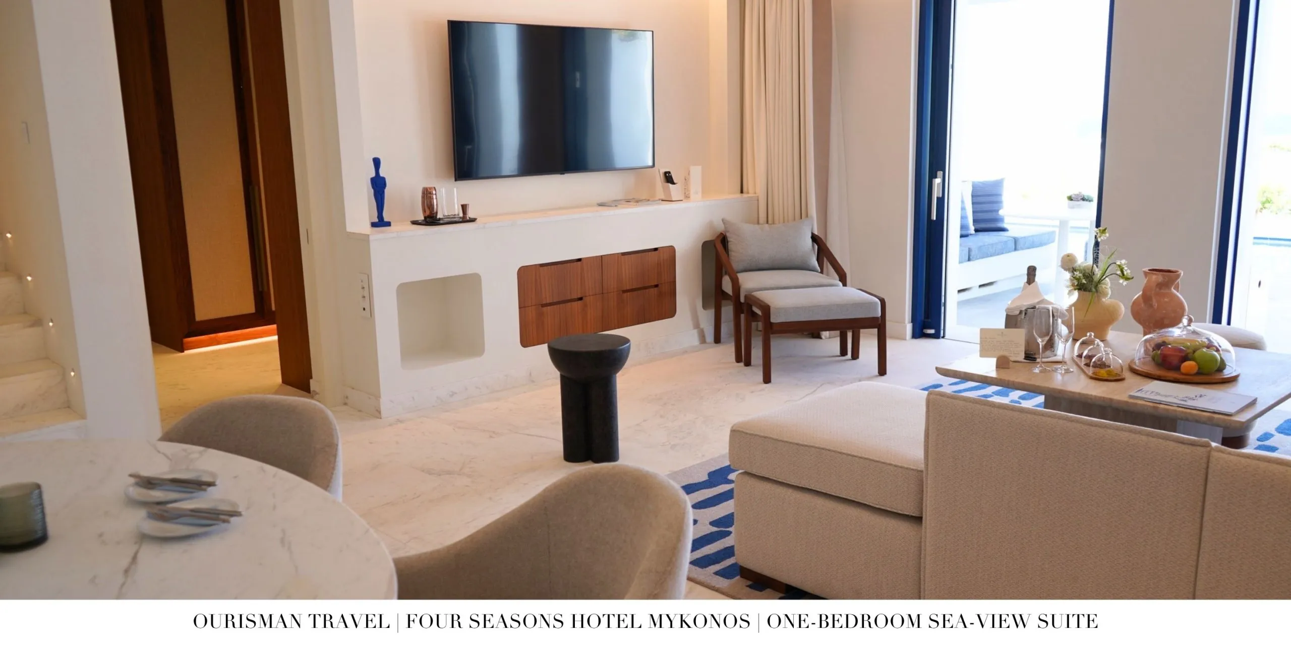 Living room with television in the One-Bedroom Sea-View Suite at Four Seasons Mykonos