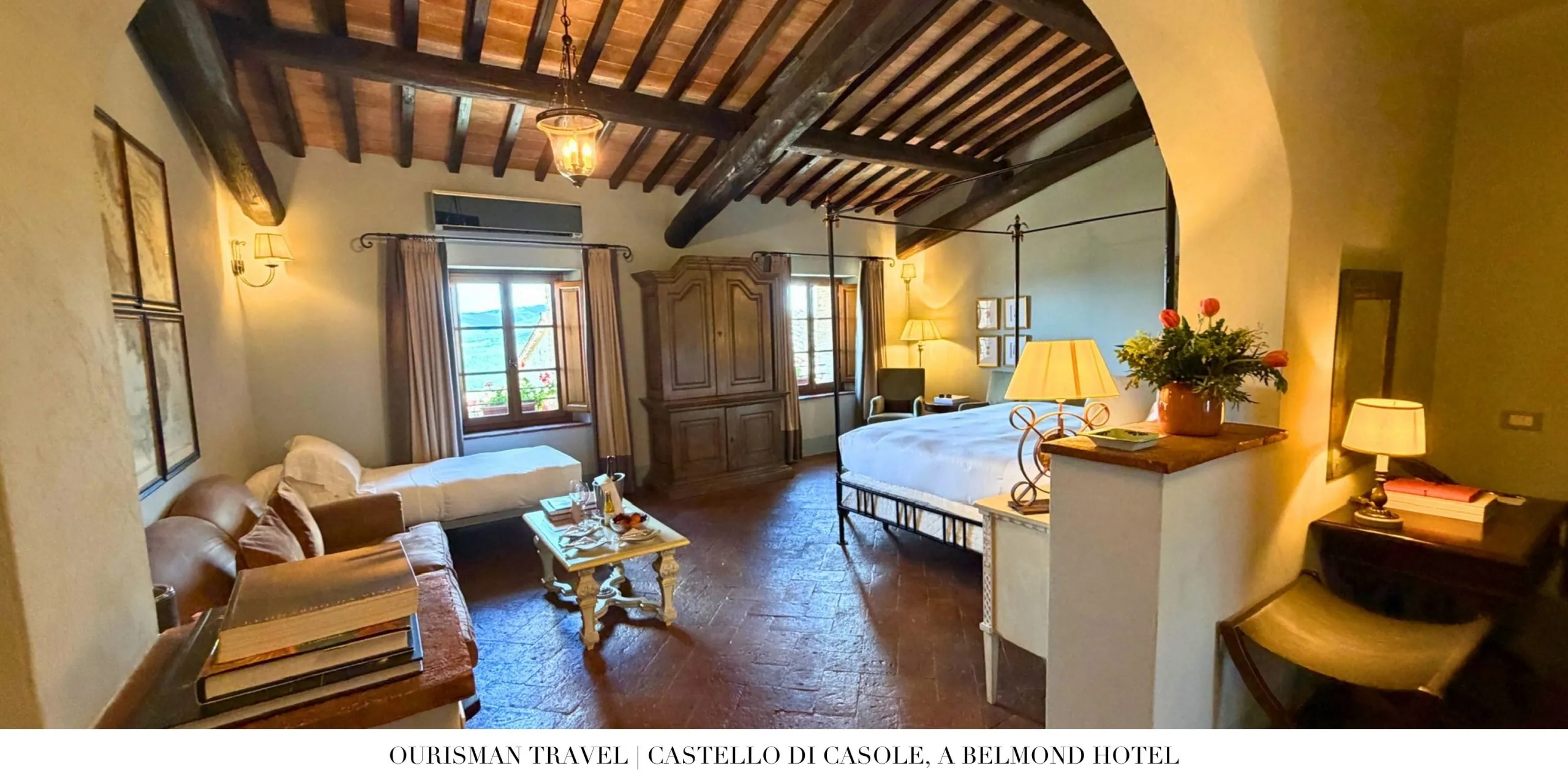 Premium Junior Suite bedroom at Castello di Casole, a Belmond Hotel, with exposed wood beams and a king bed.