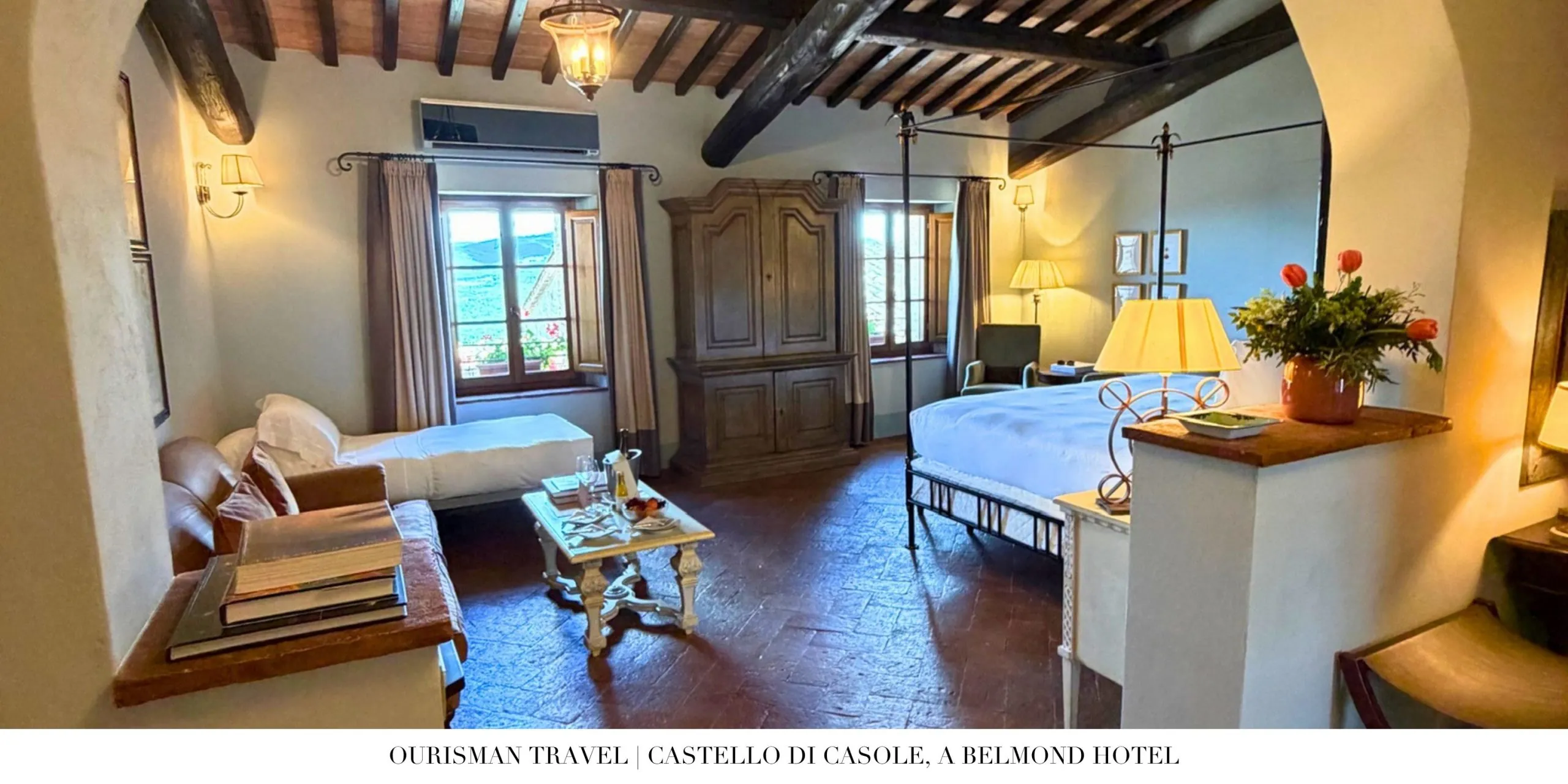 Premium Junior Suite bedroom at Castello di Casole, a Belmond Hotel, with exposed wood beams and traditional Tuscan design.