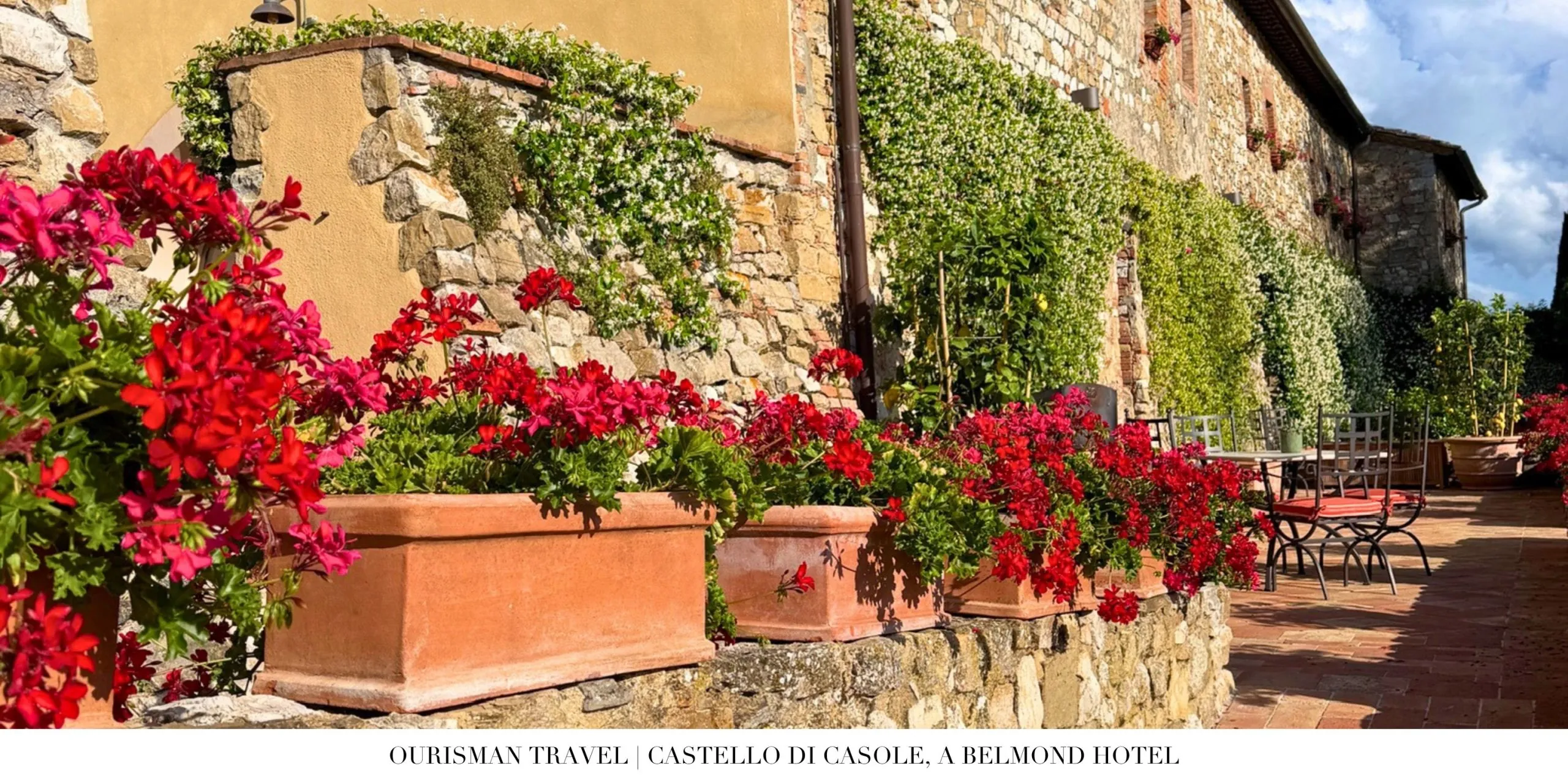 Colorful flowers outside the historic stone buildings at Castello di Casole, a Belmond Hotel in Tuscany.