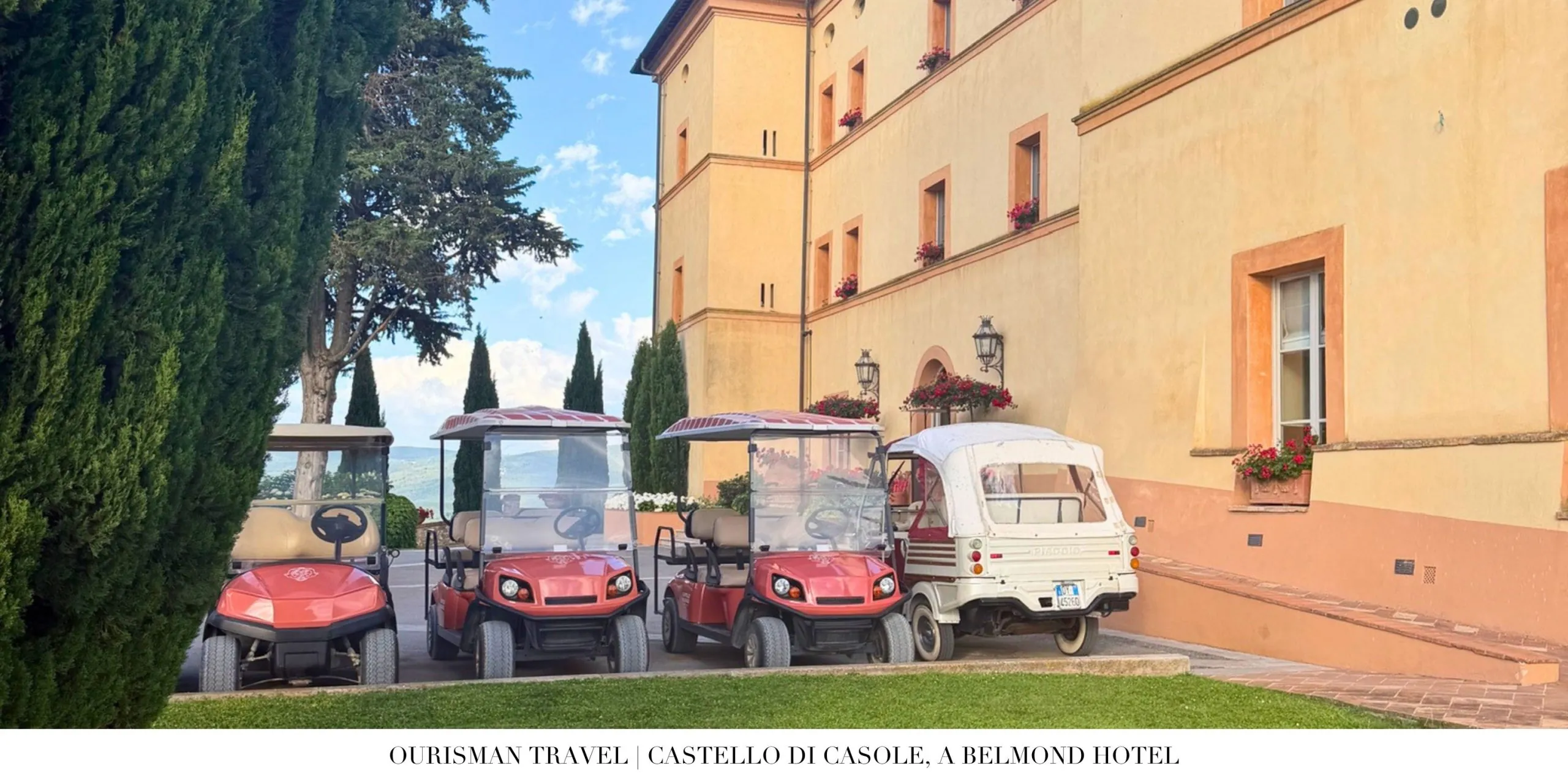 Arrival area at Castello di Casole, a Belmond Hotel, with hotel vehicles outside the main entrance.